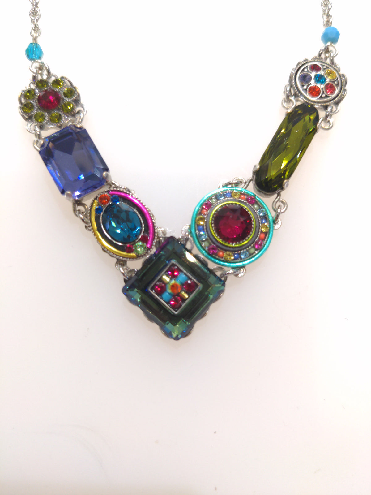 A multicolored Firefly jewelry design necklace with a variety of embellishments and a chain.