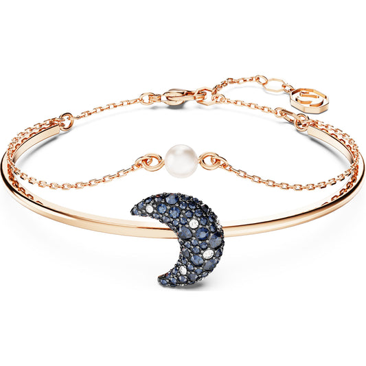 A rose gold-tone plated bangle bracelet with a multicolored moon-shaped charm and a white pearl element, branded by Swarovski.
