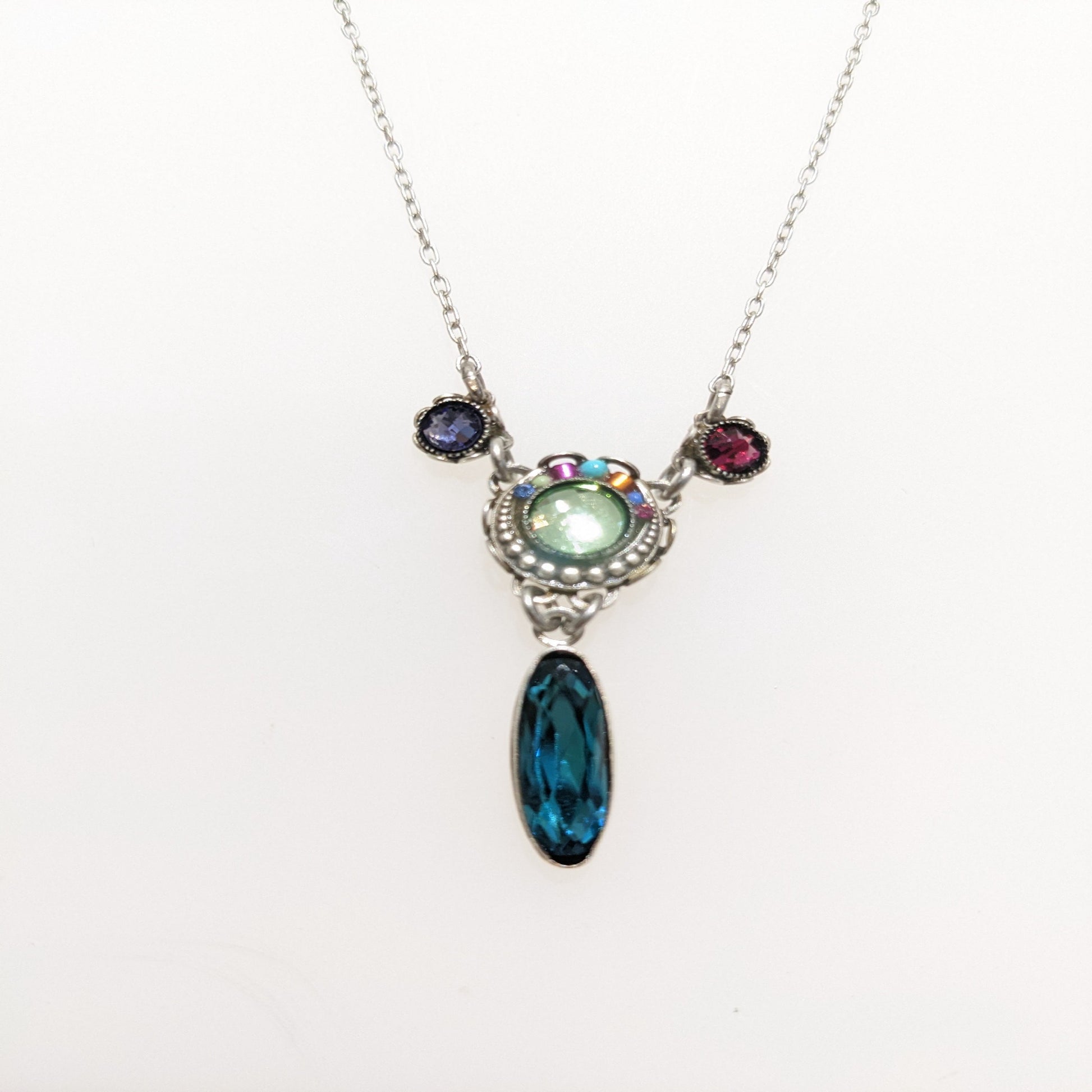 Necklace with a pendant featuring a blue teardrop and multicolored stones on a white background.