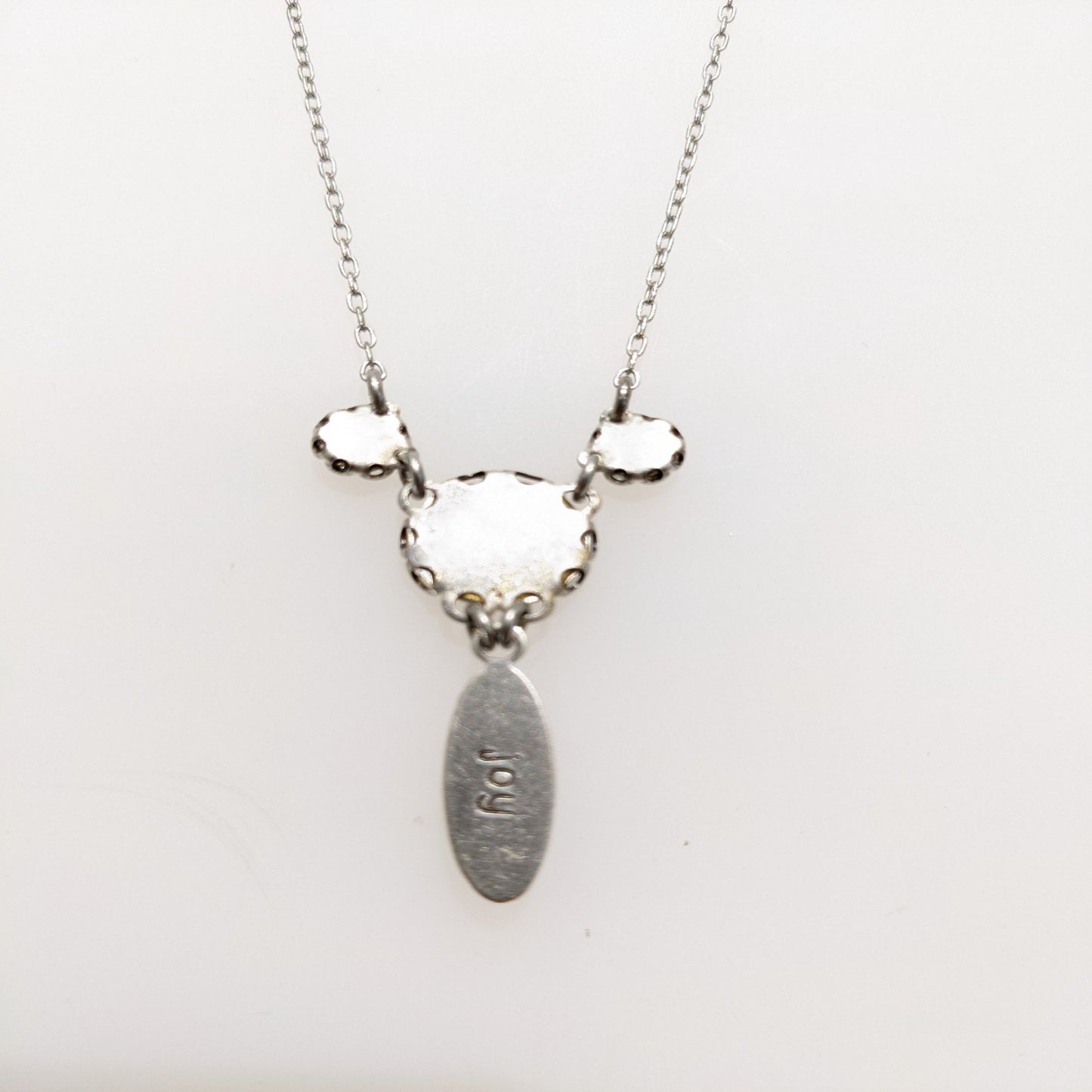 Necklace with back view on white background.