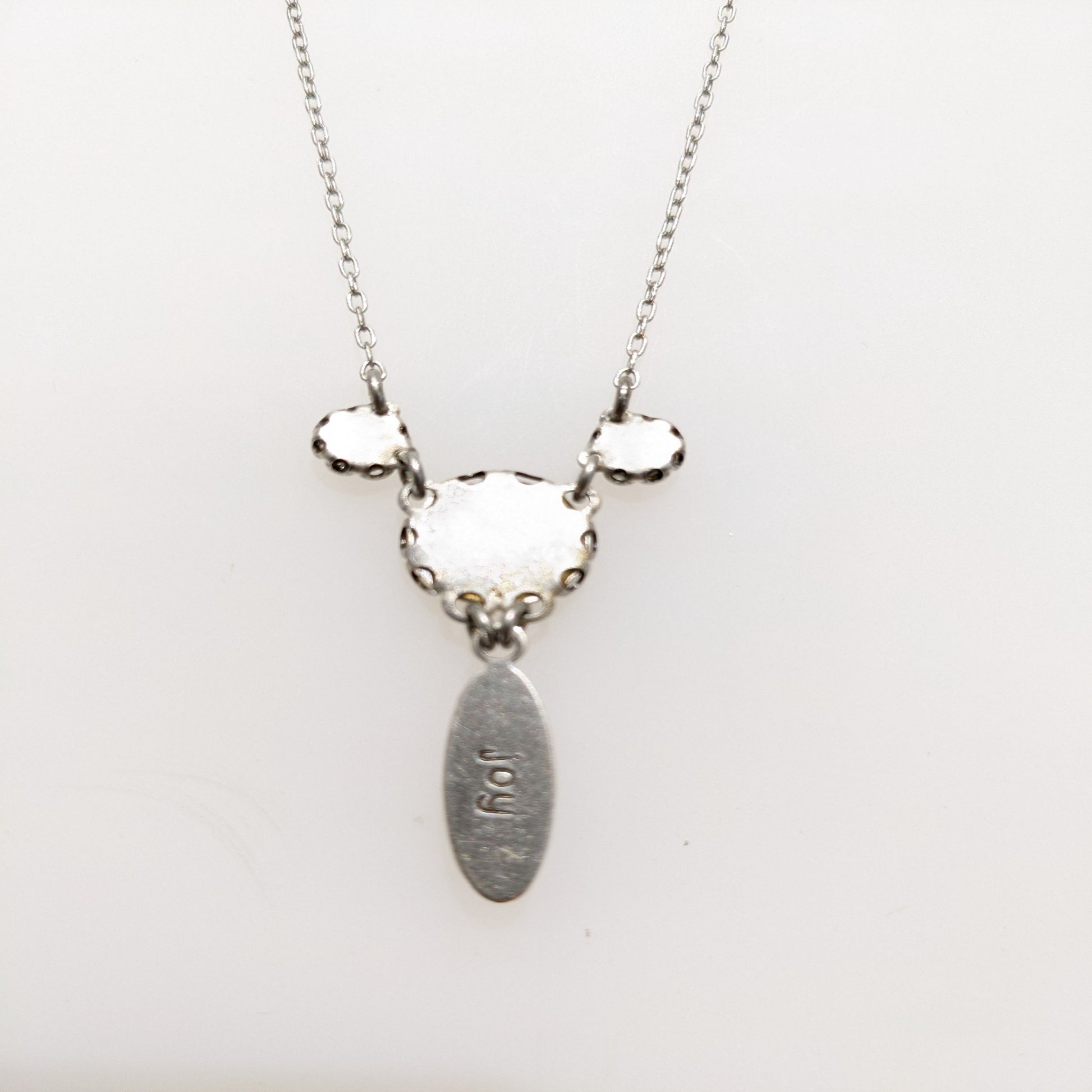 Necklace with back view on white background.