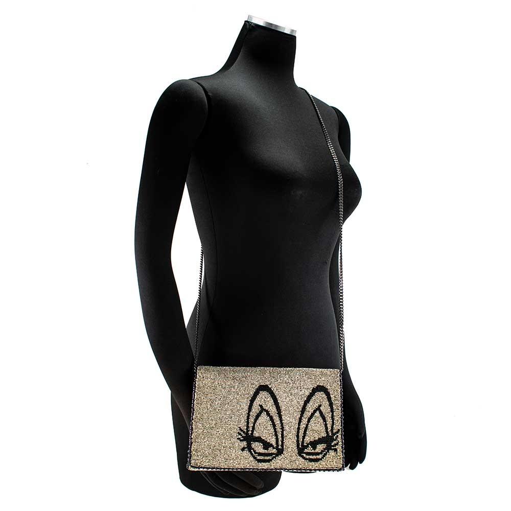 Mary Frances Crossbody Bag with a beige and black design featuring cat faces, a chain strap, and a fabric body on manikin.