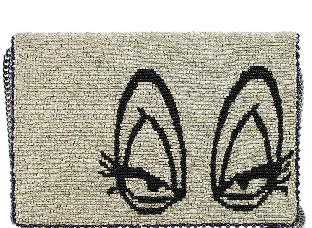 Mary Frances Crossbody Bag with a beige and black design featuring cat faces, a chain strap, and a fabric body.