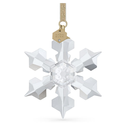 A clear crystal snowflake ornament with gold-tone lamé ribbon and champagne-gold tone accents, designed by Michele Blasilli.