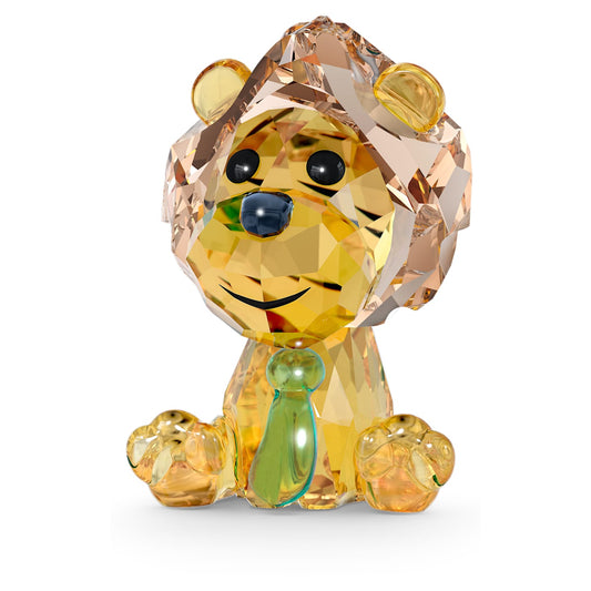 A crystal figurine of a baby lion with multi-colored crystal facets, predominantly brown in color.