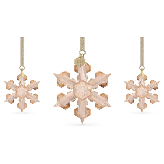 A set of three gold-toned crystal snowflake ornaments, with one large ornament featuring a golden lamé ribbon and two smaller versions without the ribbon.