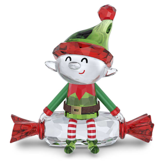 A crystal figurine of a smiling elf with green and red clothing, sitting on a present and holding candy canes.