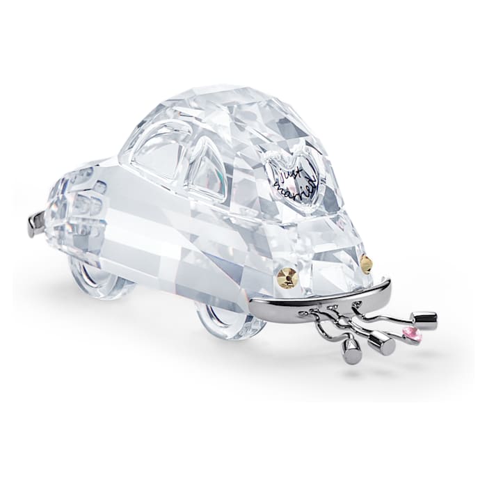 A clear crystal figurine of a car with 'Just Married' text on the back, decorated with strands representing tin cans traditionally tied to the back of a newlyweds' car.