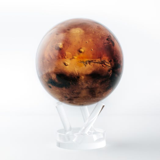 A 4.5 inch diameter globe representing the planet Mars, with a red and brown textured surface, displayed on a clear stand.