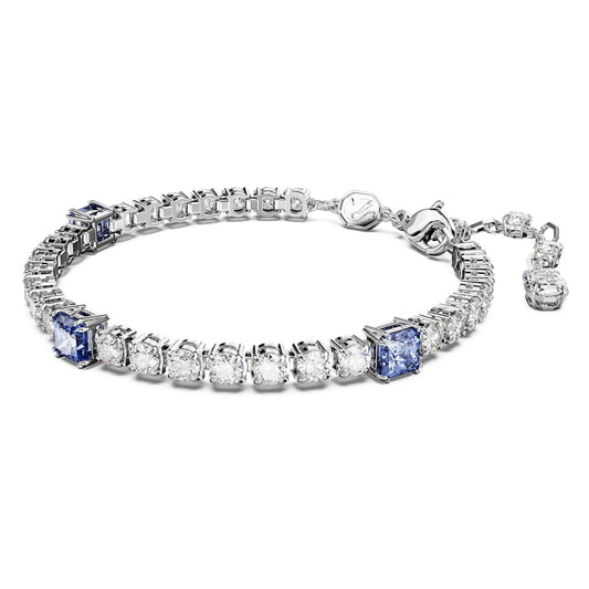 A rhodium-plated tennis bracelet with mixed cuts, featuring blue and clear crystals, and a clasp fastener.