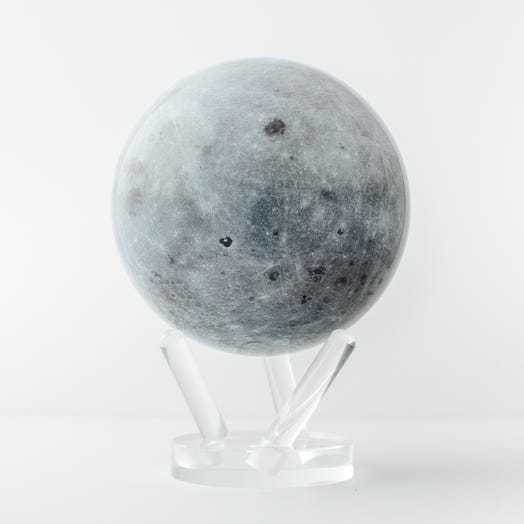 A realistic model of the moon on a clear stand, depicting its gray surface with craters.