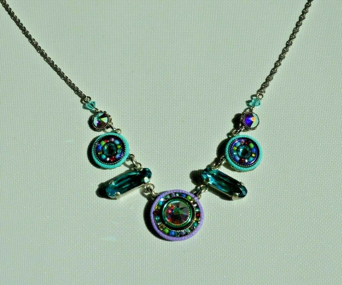 A multicolored beaded necklace with a lobster claw clasp, made with Swarovski crystals and Czech glasses, on a white background.