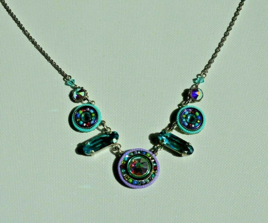 A multicolored beaded necklace with a lobster claw clasp, made with Swarovski crystals and Czech glasses, on a white background.