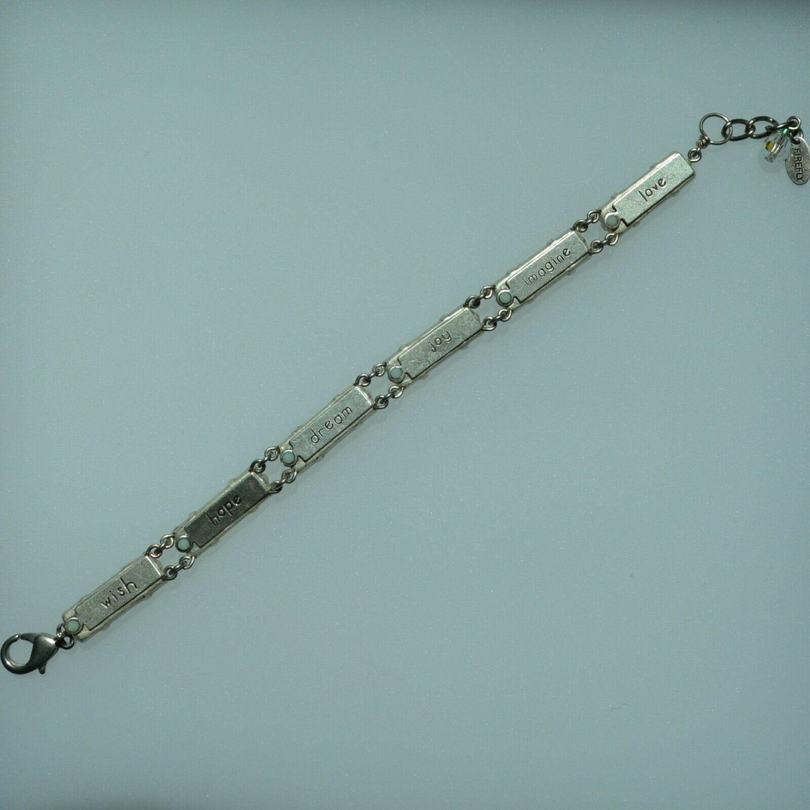 A colorful beaded bracelet with a lobster clasp, in back view.