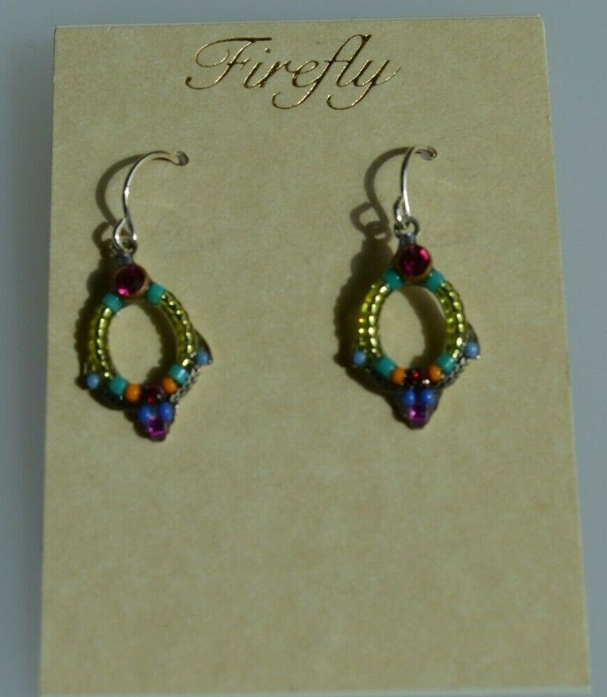 A pair of blue and multicolored beaded earrings with silver wire accents, displayed against a beige background.