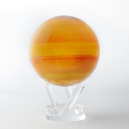 A decorative globe representing the planet Saturn with a multicolored gaseous appearance, placed on a clear stand.