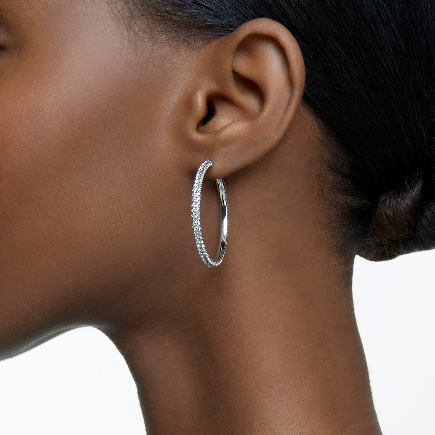 A model wearing white hoop earring.