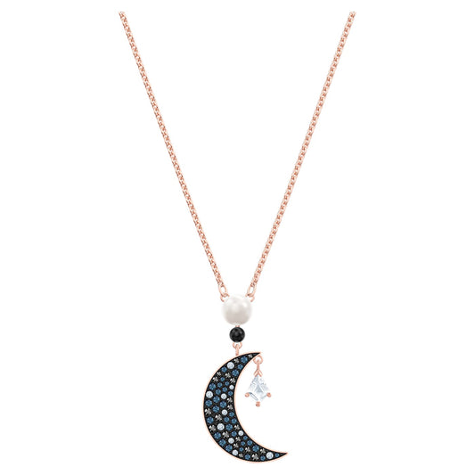 A rose gold-tone plated Swarovski pendant featuring a moon and star motif with blue crystals set in pavé.